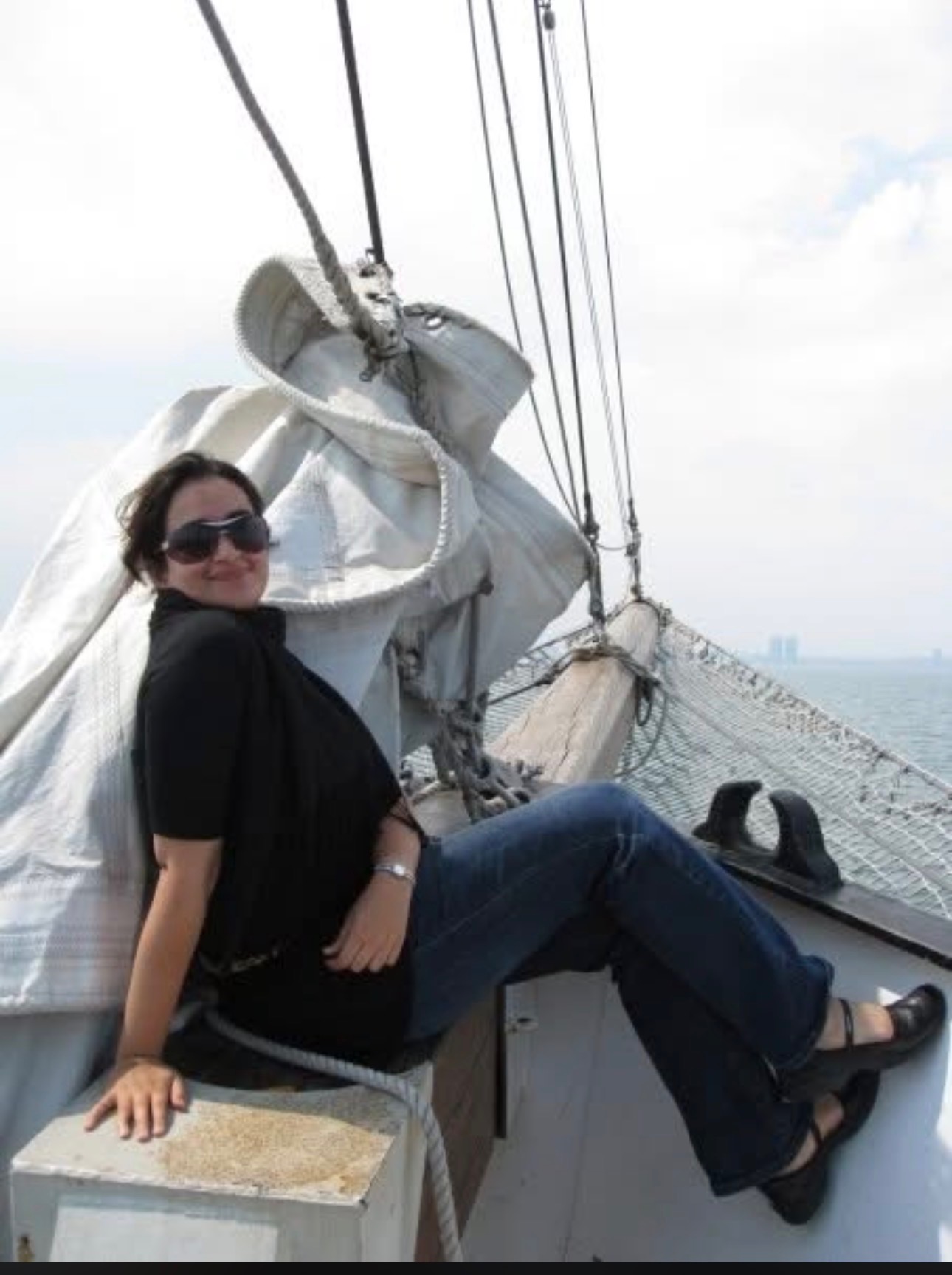 Earlier photo of Salwa sitting on a sailboat