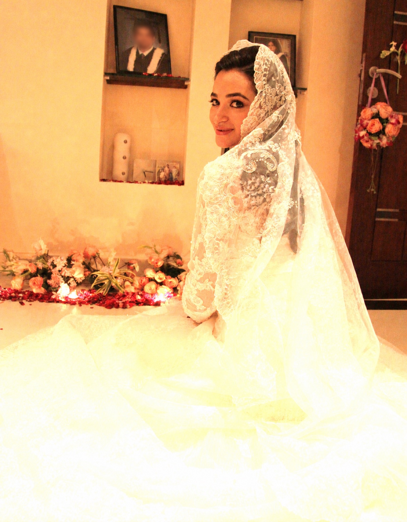 Salwa Qadir wearing a white wedding dress and lace veil